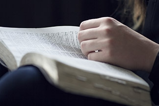 smaller graphicstock a close up of a christian woman reading the bible very shallow depth of f SBI 302048806